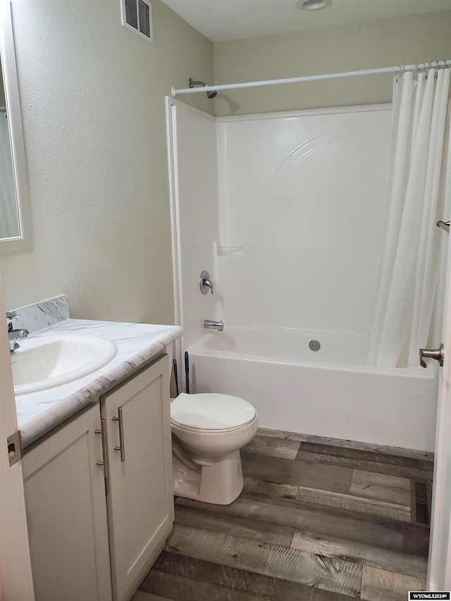 full bathroom with toilet, shower / bath combination with curtain, vanity, and wood-type flooring