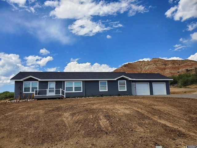 ranch-style house with a mountain view and a garage