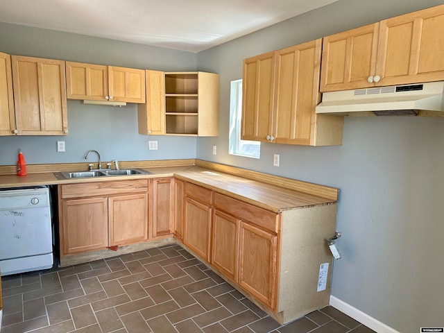 kitchen with sink, light brown cabinetry, dark tile patterned flooring, and white dishwasher