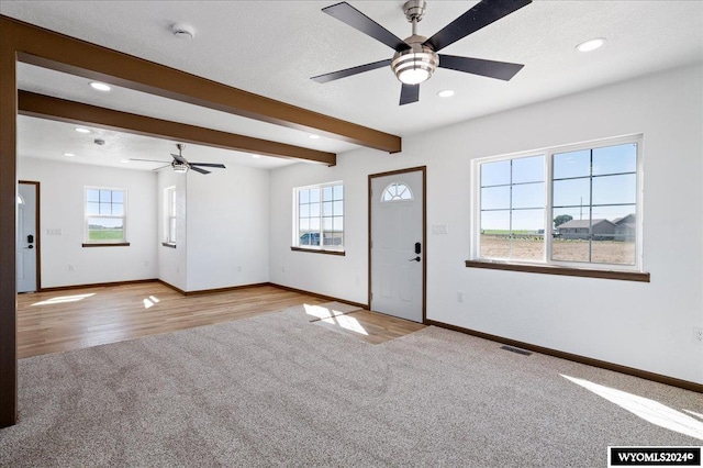 interior space featuring plenty of natural light and light colored carpet