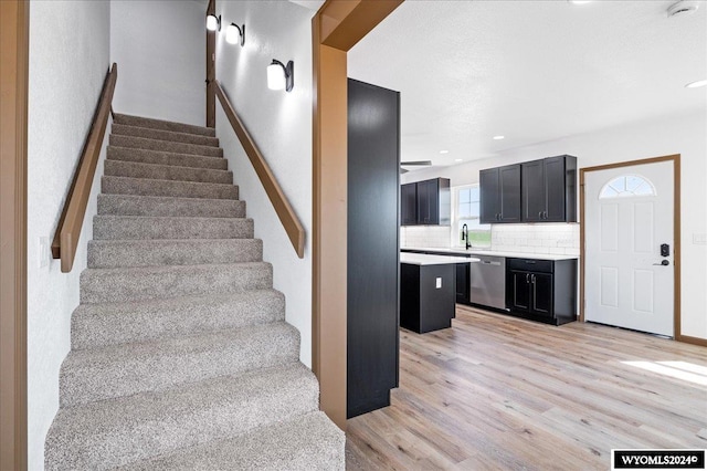 stairs featuring hardwood / wood-style floors