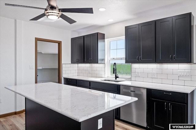 kitchen featuring dishwasher, decorative backsplash, sink, light wood-type flooring, and ceiling fan