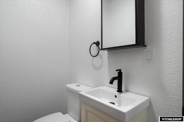 bathroom featuring toilet and vanity