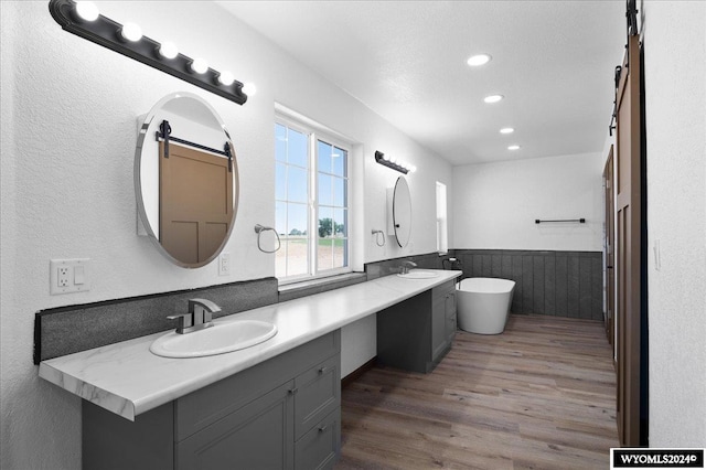 bathroom featuring dual vanity and wood-type flooring