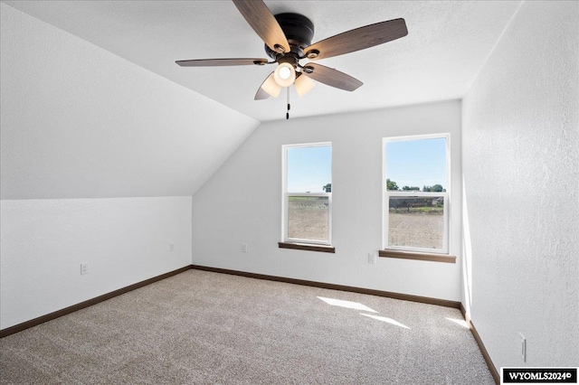 additional living space with ceiling fan, carpet, and lofted ceiling