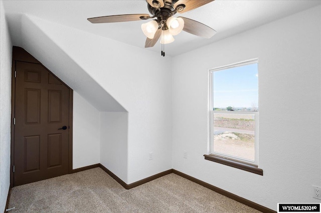 additional living space featuring ceiling fan and carpet flooring