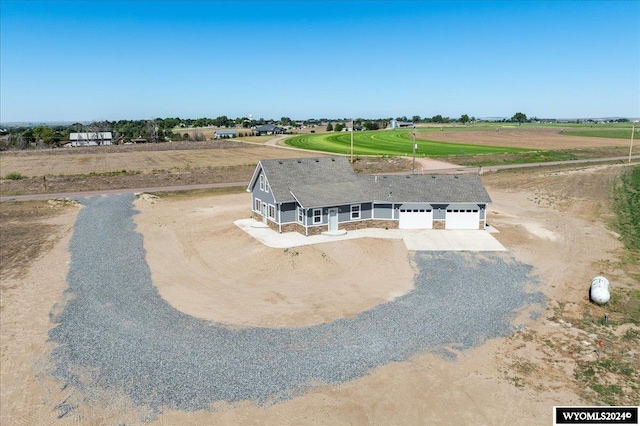 view of front facade with a garage and a rural view