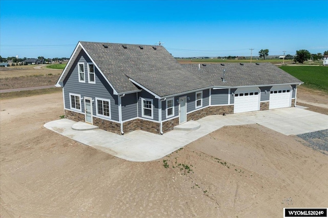 rear view of house with a garage