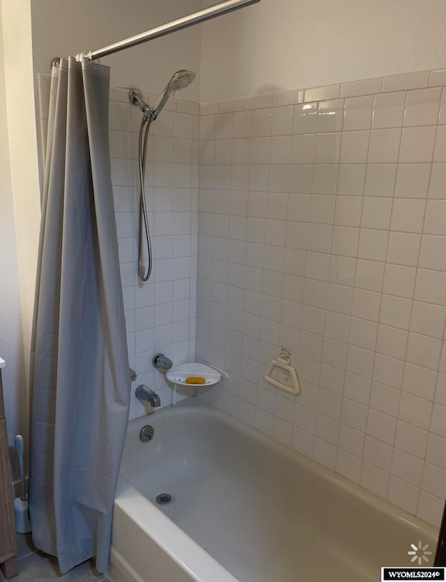 bathroom featuring shower / tub combo with curtain