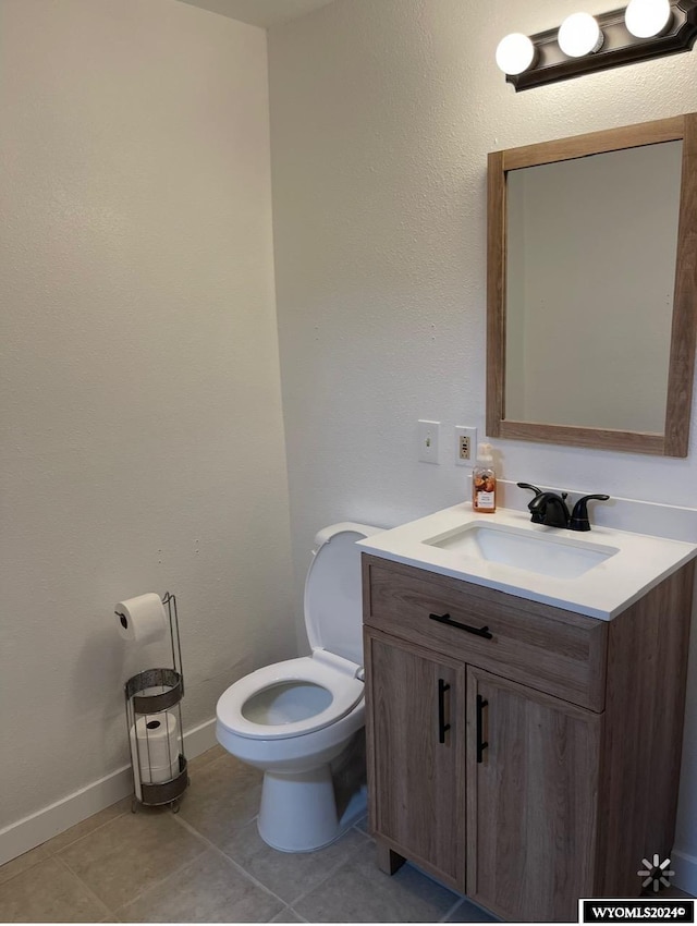 bathroom featuring toilet, vanity, and tile patterned floors