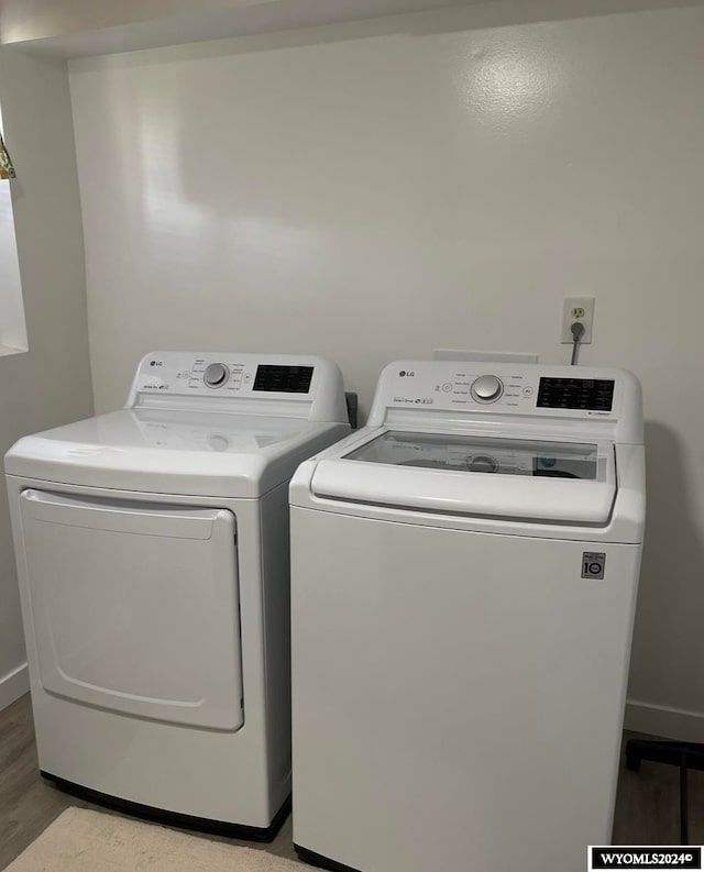 laundry area featuring light wood-type flooring and washing machine and dryer