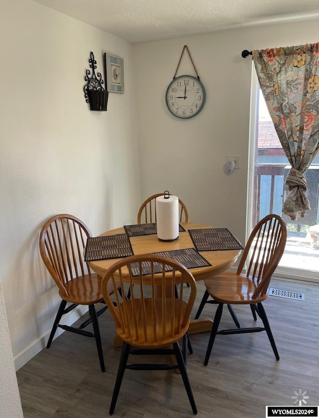 dining space with hardwood / wood-style flooring