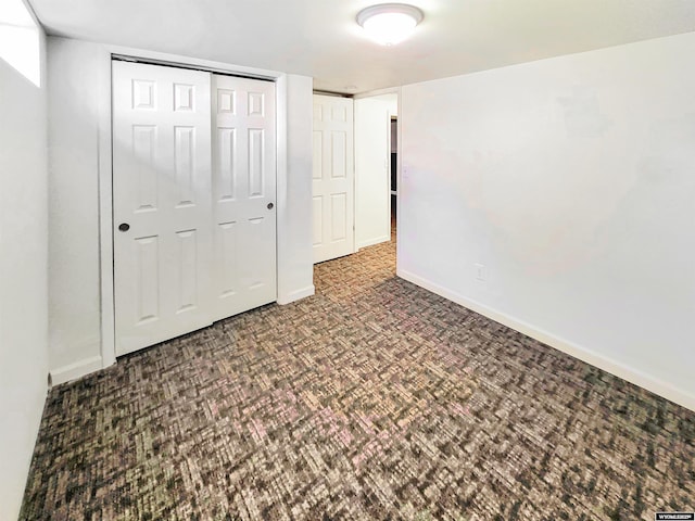 unfurnished bedroom featuring a closet and baseboards