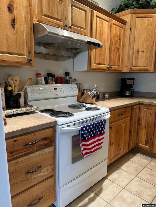 kitchen with white range with electric stovetop and light tile patterned floors