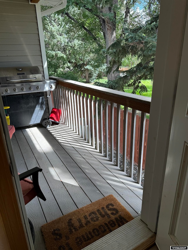 wooden terrace featuring a grill