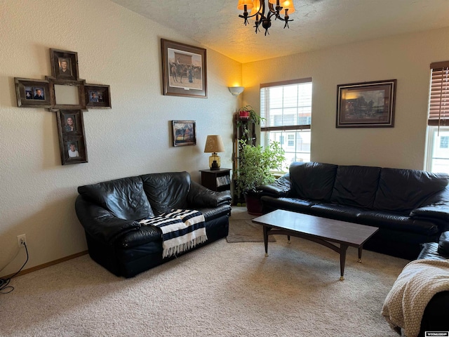 living room featuring carpet flooring, a textured ceiling, and an inviting chandelier