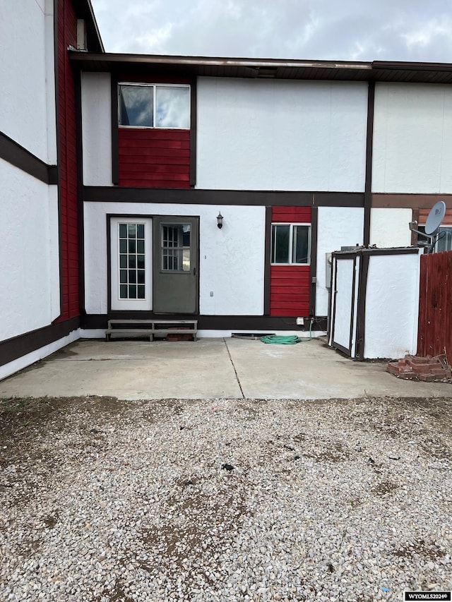 doorway to property featuring stucco siding