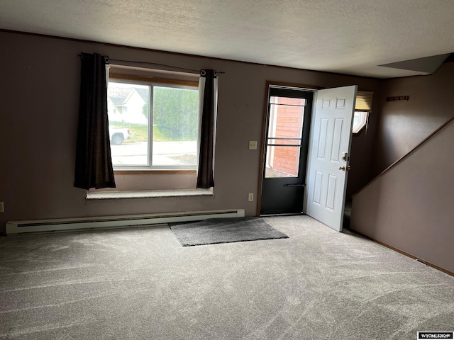 carpeted entrance foyer featuring a textured ceiling and a baseboard radiator