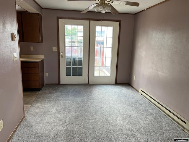 entryway featuring ceiling fan, a baseboard radiator, light colored carpet, and ornamental molding