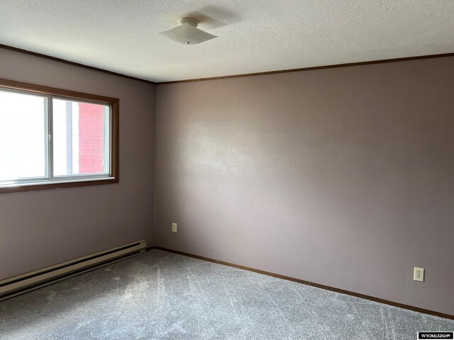 unfurnished room featuring a textured ceiling, carpet floors, and baseboard heating