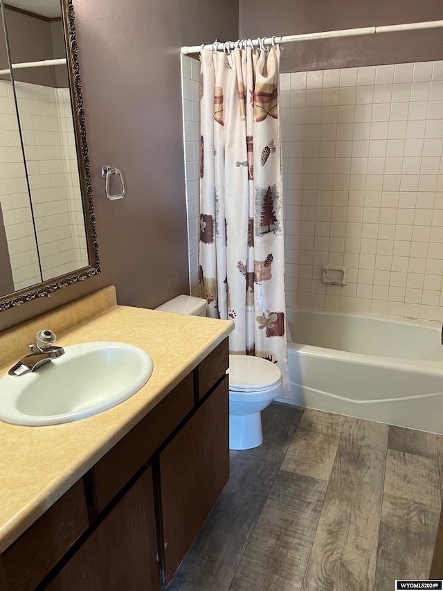 bathroom with shower / tub combo with curtain, vanity, toilet, and wood finished floors