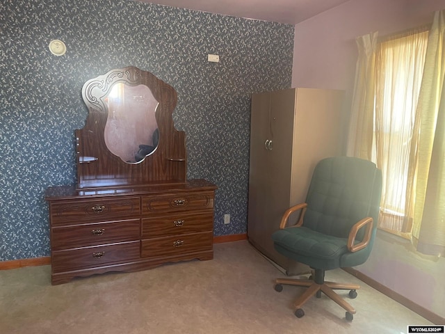 sitting room with a healthy amount of sunlight, light carpet, and wallpapered walls