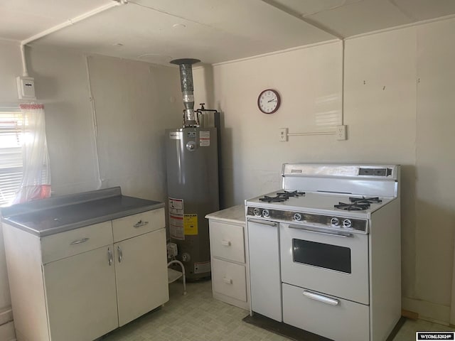 kitchen with white cabinetry, white range with gas cooktop, water heater, light floors, and dark countertops