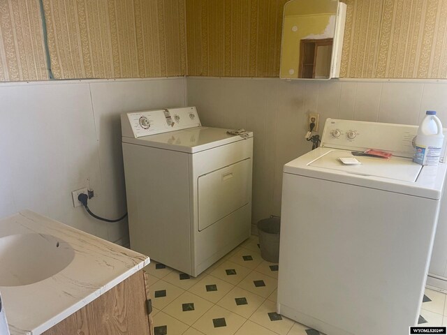 clothes washing area with light tile patterned flooring and independent washer and dryer