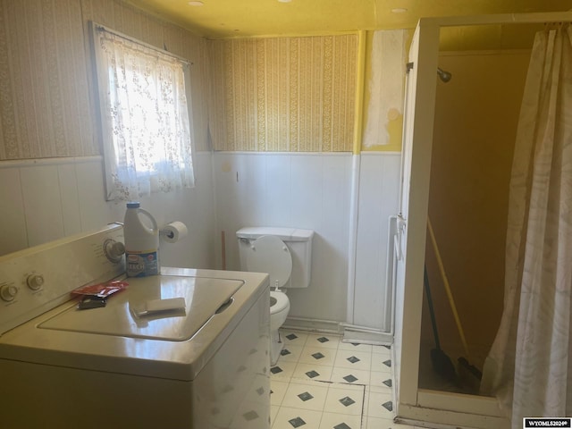 bathroom featuring tile patterned floors, washer / clothes dryer, a shower with curtain, and toilet