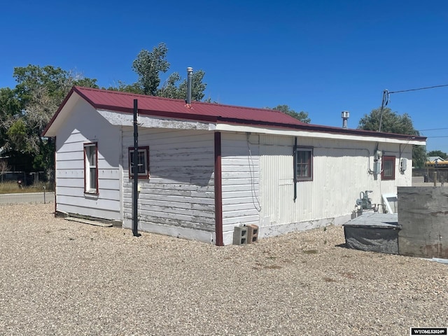 view of side of home with metal roof