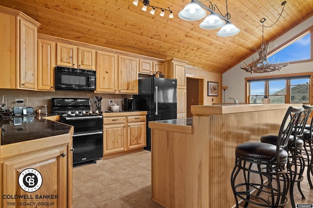 kitchen featuring black appliances, light tile patterned flooring, pendant lighting, a kitchen bar, and decorative backsplash