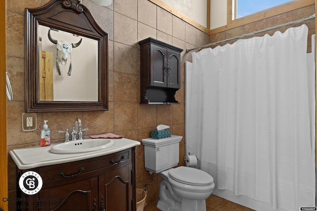 full bathroom with tile patterned floors, toilet, tile walls, shower / tub combo, and vanity