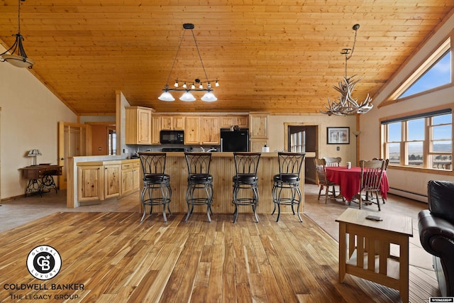 kitchen with a kitchen breakfast bar, wooden ceiling, black appliances, a notable chandelier, and light tile patterned flooring