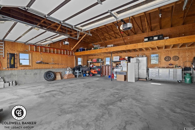 garage with a garage door opener and a workshop area