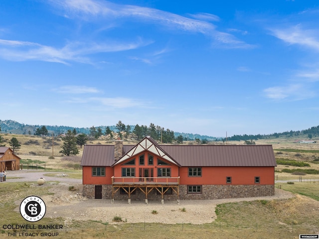 view of front facade featuring a deck and a rural view