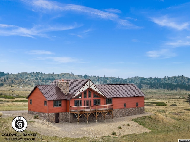 log cabin featuring a deck with mountain view