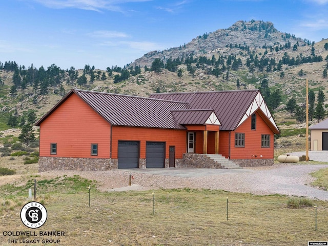 view of front of home with a garage and a mountain view