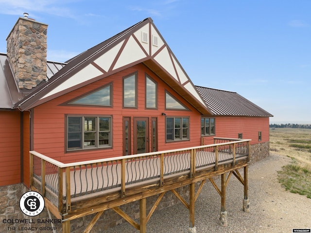 rear view of property featuring a wooden deck and a rural view