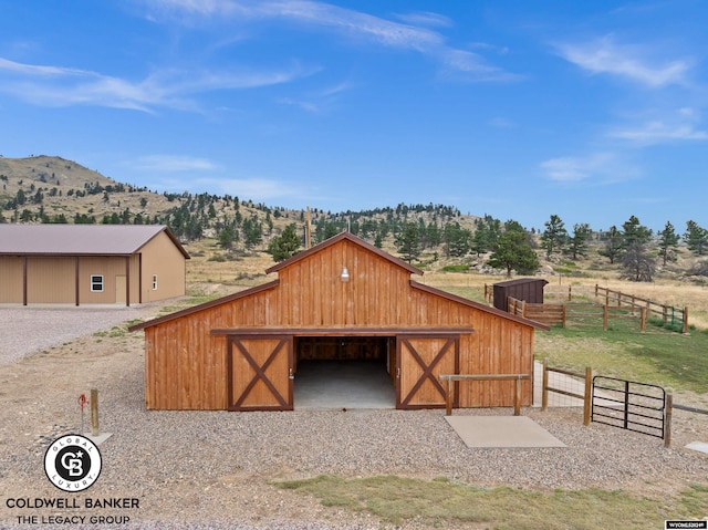 garage with a rural view and a mountain view