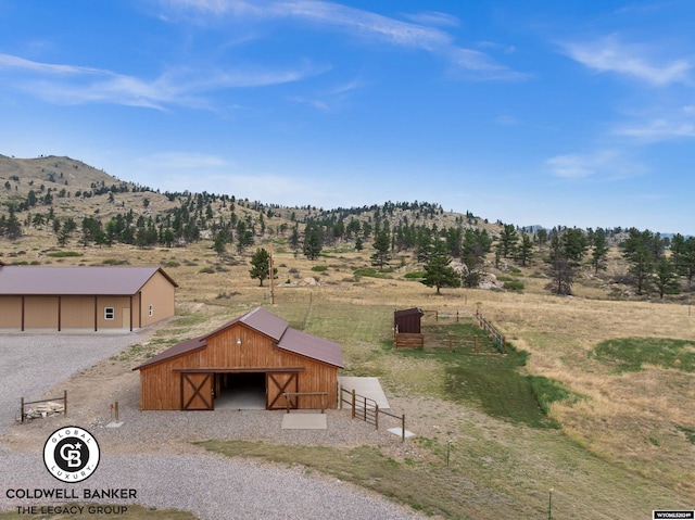 exterior space with a mountain view, an outdoor structure, and a rural view