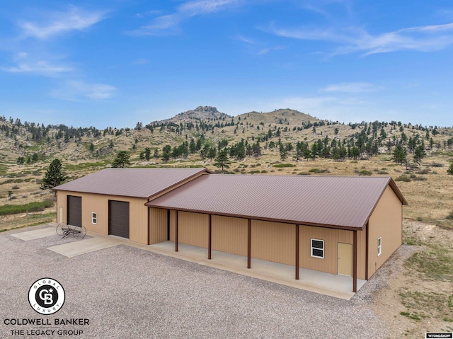 view of front of home with a mountain view and a garage