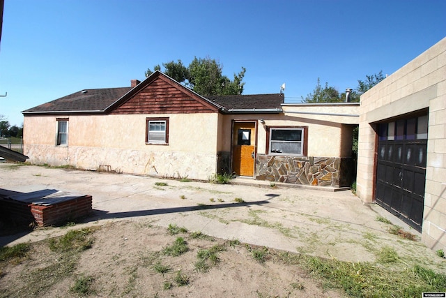 213 10th Ave, Lyman, NE 69352 - view of front of home featuring stucco siding, an attached garage, and stone siding