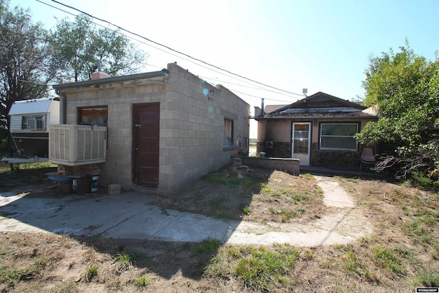 213 10th Ave, Lyman, NE 69352 - back of house featuring concrete block siding