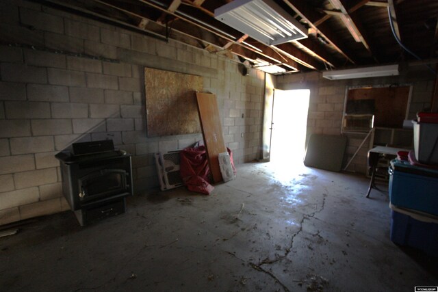 213 10th Ave, Lyman, NE 69352 - unfinished below grade area featuring a wood stove and concrete block wall