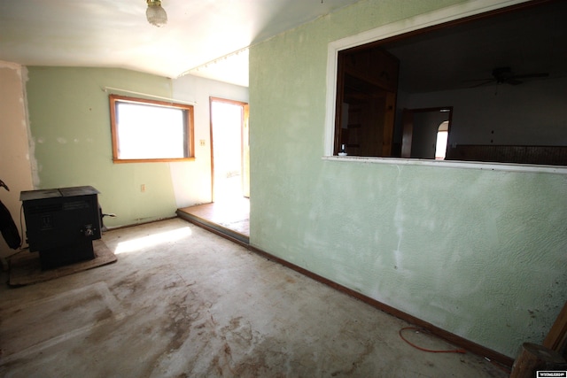 213 10th Ave, Lyman, NE 69352 - unfurnished living room featuring lofted ceiling, a ceiling fan, and a wood stove