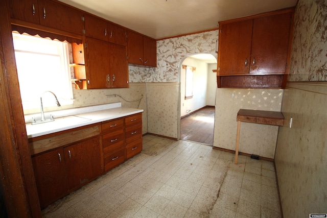 213 10th Ave, Lyman, NE 69352 - kitchen with a wealth of natural light, wallpapered walls, light floors, and a sink