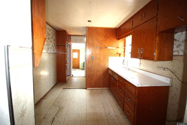 213 10th Ave, Lyman, NE 69352 - kitchen featuring brown cabinetry, light floors, and light countertops