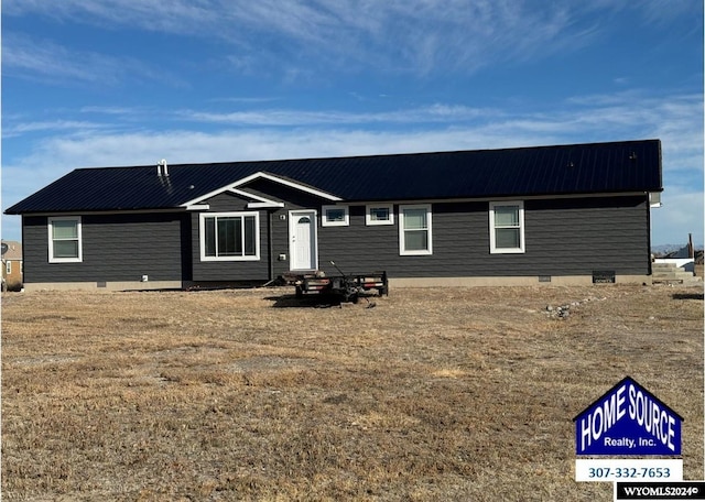 view of front of home featuring crawl space and metal roof