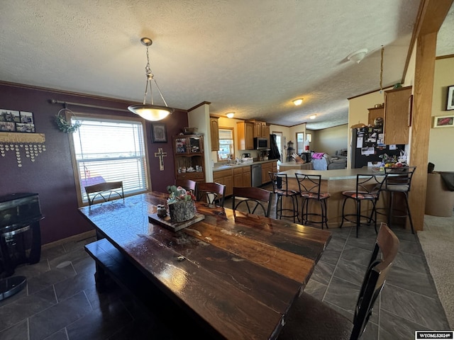 dining area with baseboards and a textured ceiling