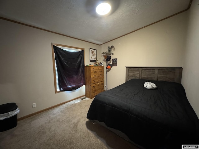 carpeted bedroom featuring a textured ceiling, baseboards, and ornamental molding